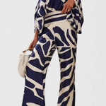 Sybella Conjunto de Dos Piezas con Hombros Descubiertos y Pantalones Amplios Estampados Alba Madrid